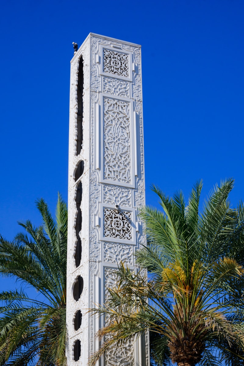 A tall white tower with a clock on it's side